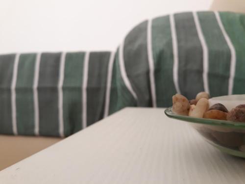 a bowl of food on a table next to a couch at O lastraco in Trapani
