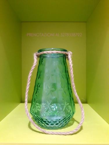 a green glass vase with a rope around it at O lastraco in Trapani