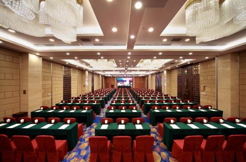 an empty conference room with red chairs in it at Hotel Landmark Canton in Guangzhou