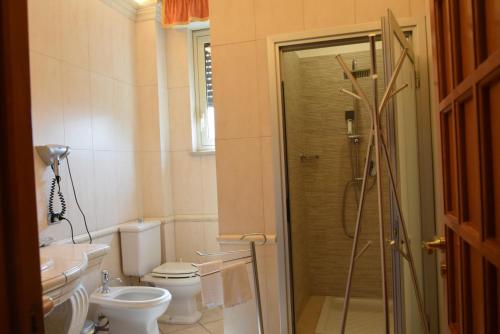 a bathroom with a shower and a toilet and a sink at La Suite del Vulcano in Belpasso