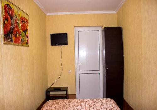 a bedroom with a bed and a tv on the wall at Matras Hotel in Kyiv
