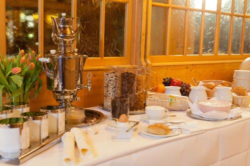 a table with food and dishes on it at Alemannenhof in Schallstadt-Mengen