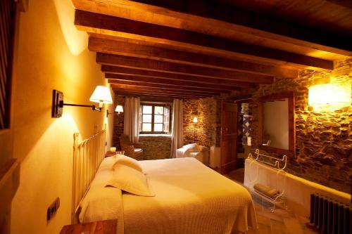 a bedroom with a large white bed in a room at Areal in Viveiro