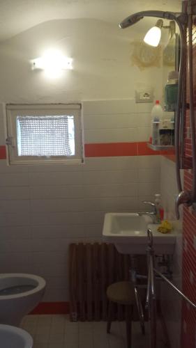 a bathroom with a sink and a toilet and a window at nel centro storico casa vacanze I Mughetti in Citta' Sant'Angelo