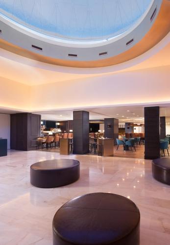 a lobby with tables and chairs in a building at Stanford Court San Francisco in San Francisco