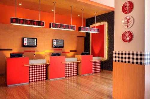 a fast food restaurant with red and orange counters at Ibis Bali Kuta in Kuta