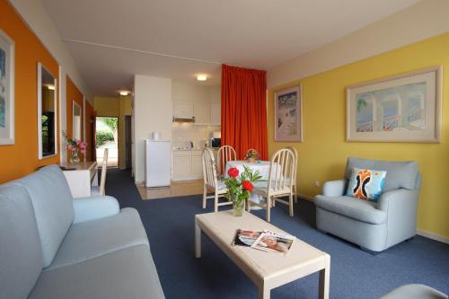 a living room with a couch and a table at Canico Bay Apartments in Caniço