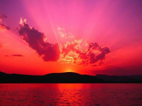 a sunset over a body of water at Kalama Apartments in Kálamos