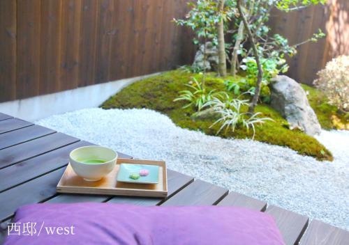 a bowl on a tray on a table in a garden at Houka in Kyoto