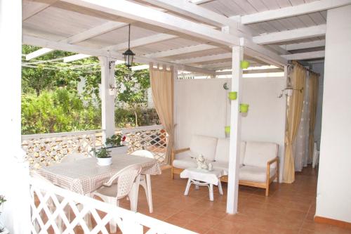 a patio with a table and chairs on a balcony at Villa Paradiso in Gaeta