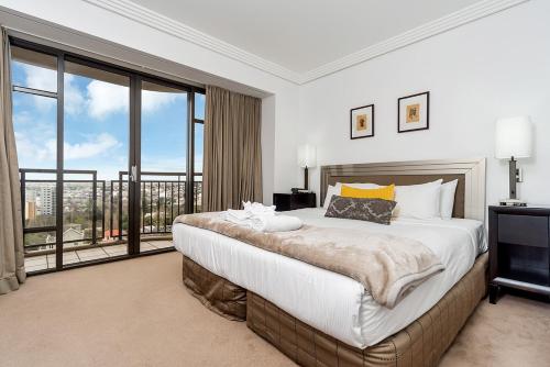 a bedroom with a large bed and a large window at QV Stays Peace and Style in the Iconic Metropolis in Auckland