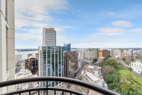 a view of a city from the balcony of a building at QV Stays Peace and Style in the Iconic Metropolis in Auckland