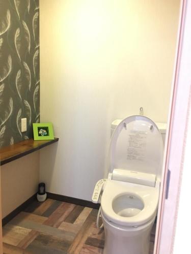 a bathroom with a toilet with the lid up at Nikko Park Lodge Tobu Station in Nikko
