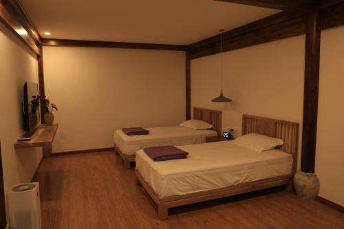 a room with two beds and a tv in it at Beijing Downtown Travelotel in Beijing
