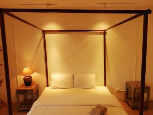 a bedroom with a four poster canopy bed at Coco Country Homes in Melaka