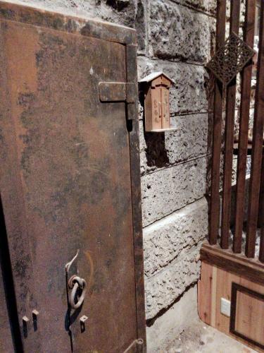 an old metal door with a bird house on a wall at Nikko Park Lodge Tobu Station in Nikko