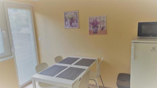 a white table and chairs in a room at Apartmá Andělka in Lipova Lazne