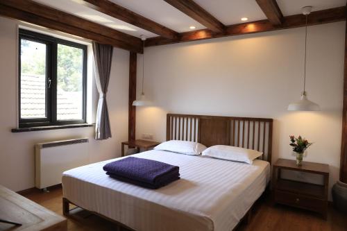 a bedroom with a large bed with white sheets at Beijing Downtown Travelotel in Beijing