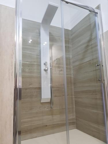 a shower with a glass door in a bathroom at Residenza Lumière in Termoli