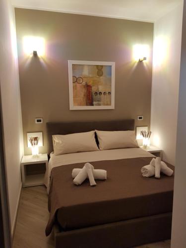 a bedroom with a large bed with two pillows on it at Residenza Lumière in Termoli