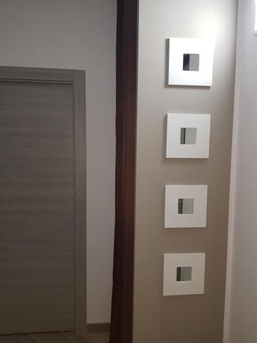 a room with a door and a wall with pictures on it at Residenza Lumière in Termoli
