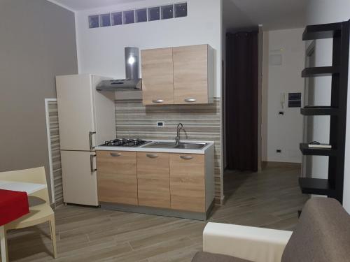 a kitchen with a sink and a stove at Residenza Lumière in Termoli