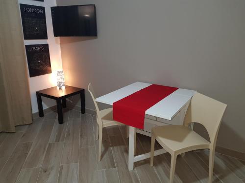 a table and chairs with a red blanket on it at Residenza Lumière in Termoli