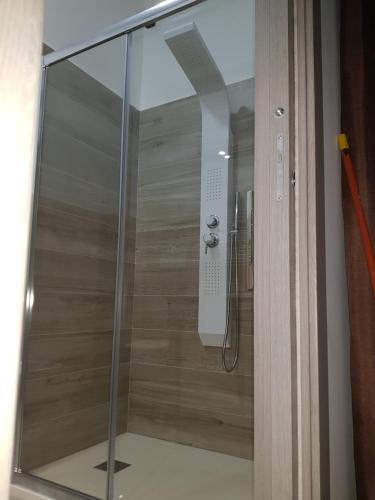 a shower with a glass door in a bathroom at Residenza Lumière in Termoli