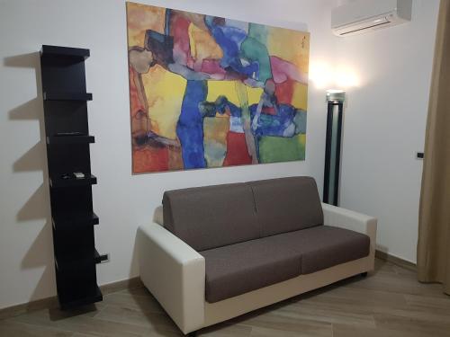 a couch in a room with a painting on the wall at Residenza Lumière in Termoli