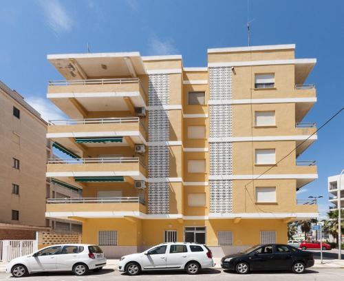 a building with three cars parked in front of it at River in Daimuz