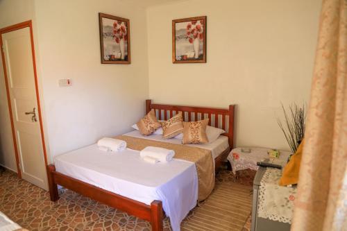 a bedroom with two beds in a room at Dream Holiday Self Catering in La Digue