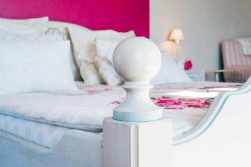 a bedroom with a bed with a mirror next to it at Feniks Agro&Spa Adults Only in Świnoujście