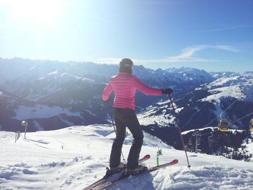 a person on skis standing on top of a mountain at alpenrose hotel-garni in Gerlos
