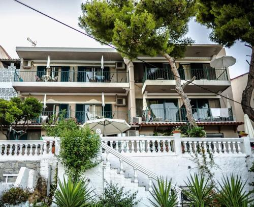 a building with stairs in front of it at Mina Apartments in Poros