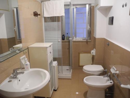 a bathroom with a sink and a toilet at Addaura Mozzafiato in Mondello