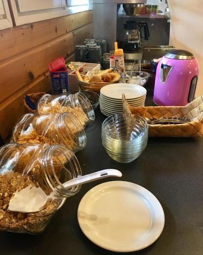 a counter top with plates and baskets of food at Arctic Lodge Hetan Kota in Enontekiö