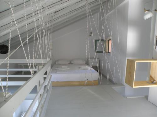 a room with a bed in the attic at Spitakia in Vourkari