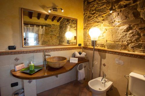 a bathroom with a sink and a bowl on a counter at Tangohotel in Lucca