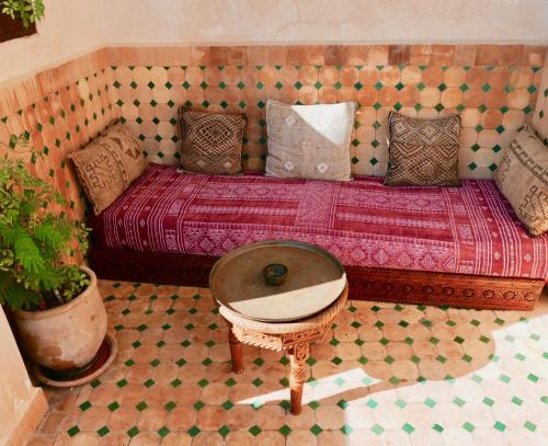 a room with a bed with a table and a table sidx sidx at La Tour de L'air in Tangier