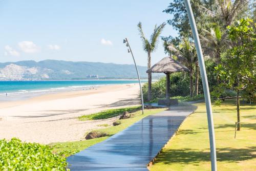 a walkway to the beach at a resort at Van-Pretty Residence Haitang Bay Sanya in Sanya