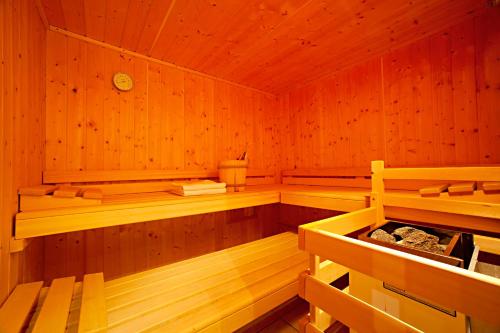 a sauna with wooden walls and wooden shelves at Ferienhaus Knor in Umhausen