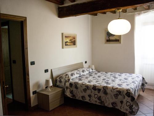 a bedroom with a bed and a lamp at La Dimora di Angela in Barberino di Mugello