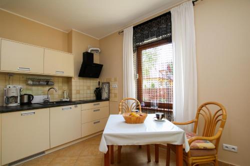 a kitchen with a table and chairs and a window at Apartment 1 in Rewal