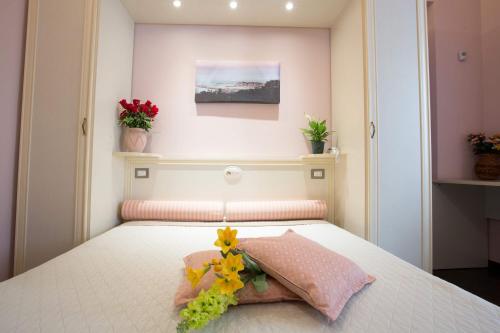 a bedroom with a bed with flowers on it at Relais Parallelo 41 in Vieste