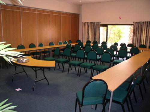 a conference room with tables and chairs in it at Eagles Nest Lodge in Johannesburg