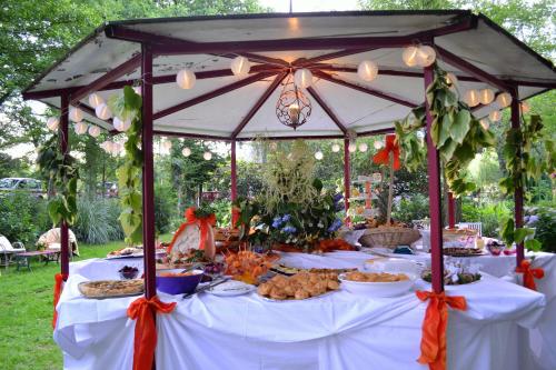 a gazebo with a table with food on it at Le Moulin du Bignon in Lassy