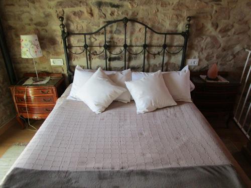 a bedroom with a bed with white pillows at Ca'ls avis in Serra