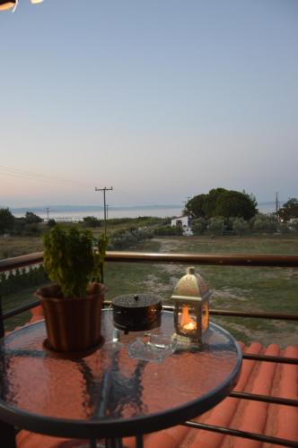 a table with a candle on top of a patio at Ktima Argiri in Ormos Panagias