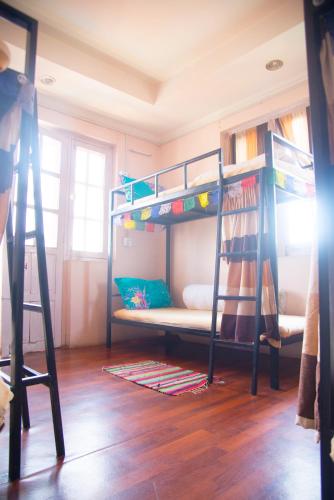 two bunk beds in a room with a wooden floor at Wander Thirst in Kathmandu