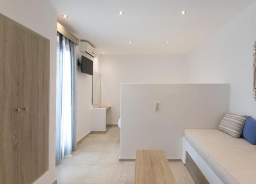 a living room with a couch and a table at Naxos Colosseo in Agios Prokopios